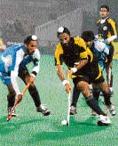 Rajpal Singh of Chandigarh Dynamos being tackled by Sardar Singh of Hyderabad Sultans during the inaugural match of the PHL at Hockey Stadium, Sector 42, Chandigarh on Thursday.