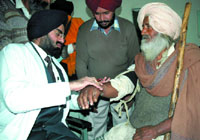 A doctor attending to a patient at the civil hospital in Bathinda on Friday.