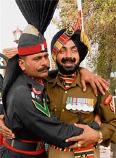 A Pakistani Ranger greets a BSF jawan on Id-ul-Zuha at Attari border in Amritsar on Friday.