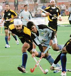Parbodh Tirkey (R) of Orissa Steelers being checked by Sandeep Singh of Chandigarh Dynamos during the PHL match in Chandigarh on Saturday.
