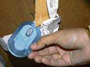 The name tag on a suitcase bearing her name.