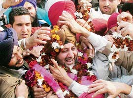Supporters garland former Congress MLA Jasbir Singh Dimpa after his release from the central jail in Amritsar on Monday