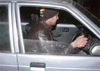 The suspect escapes in his car.