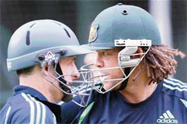Australian batsmen Andrew Symonds (R) and Michael Hussey chat while they wait for their turn to bat during training at the MCG in Melbourne on Monday. 