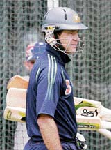 Ricky Ponting holds his bats as he awaits his turn to bat during training at the MCG in Melbourne on Monday.