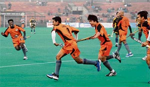 Cheeyanna (2L) of Bangalore Hi-Fliers and his team mates celebrate after scoring the final goal against Chandigarh Dynamos during the Premier Hockey League at Hockey Stadium, Sector 42, in Chandigarh on Tuesday.