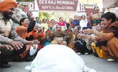 Teachers, with the effigy of CM Parkash Singh Badal, protesting against the education policy of the Punjab government in Bathinda on Wednesday.