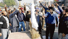 Government teachers prepare to burn an effigy of the Punjab government at Tahli Wala Chowk in Rajpura on Wednesday.