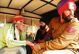 Gurcharan Singh (in black turban) and his accomplice in police custody in Ludhiana on Thursday. 