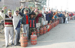 Customers protesting against the non-availability of LPG outside a gas agency in Bathinda on Saturday.