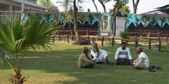 People sitting in the cremation ground, Mansa.