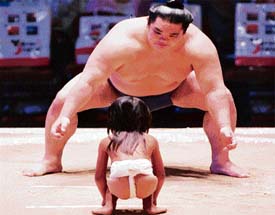 Mountain & Molehill: Fortunately, this girl didn�t have to fight against the sumo wrestler � she just got some tips from him at an event in Hawaii. 