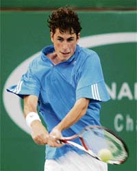 Robin Haase of the Netherlands plays a return to Marcos Baghdatis of Cyprus during their first round match at the ATP Chennai Open in Chennai