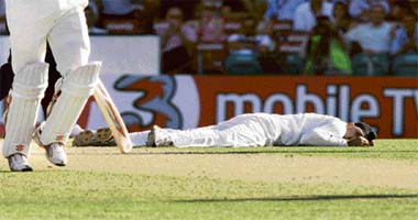 India�s Harbhajan Singh lies on the ground after falling while attempting to field off his own bowling during day one of the second Test against Australia at the Sydney Cricket Ground