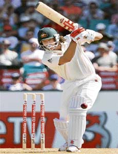 Andrew Symonds drives the ball on his way to a century at Sydney