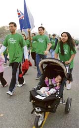 A foreign delegate and her child take part in the Countdown Run organised by the 2010 Delhi Commonwealth Games Organising Committee in the Capital on Sunday.