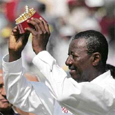 West Indies� umpire Steve Bucknor shows a memento to mark the umpiring of his 100th Test