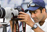 Anil Kumble takes a picture with a photographer�s camera during the first day of the warm-up match against Australian Capital Territory XI in Canberra on Thursday.