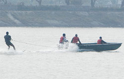 A person engaged in water surfing at a lake in Bathinda