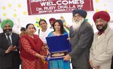 Chief minister Parkash Singh Badal presenting a souvenir to Ruby Dhalla (centre), MP in Canada, in Badal village on Thursday.