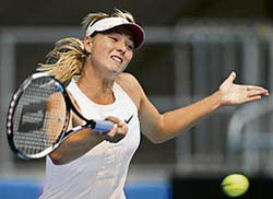Russia�s Maria Sharapova hits a return to compatriot Elena Dementieva during the pre-quarterfinal of the Australian Open in Melbourne on Sunday. Sharapova won 6-2, 6-0.