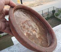 Water kept in an earthen bowl for birds by a city resident froze on Tuesday morning.