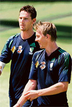 Australia's Shaun Tait (L) and Brett Lee talk in the nets during a training session at the Adelaide Oval stadium