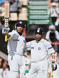 VVS Laxman (L) acknowledges the crowd after completing his fifty as Sachin Tendulkar congratulates him on the first day of the fourth Test at the Adelaide Oval on Thursday.