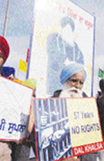 A member of the Dal Khalsa holds a poster during a rally on the Bhandari Bridge in Amritsar on Friday. Photo: Vishal Kumar