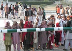 People on the Pakistan side wave to their relatives in the Indian territory at Sadqi joint check post on the Indo-Pakistan border in Fazilka on Saturday.