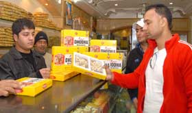 An NRI purchasing a pack of Dhodha sweet from the oldest shop at Kotkapura in Faridkot district. 