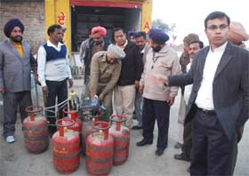 Officials seizing cylinders in Bathinda