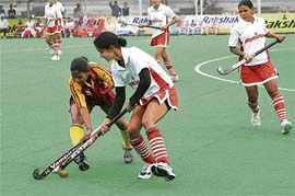 Punjab and Jharkhand players vie for the ball during their match at the ongoing 55th Rakshak Senior Women National Hockey Championship in Jalandhar on Sunday