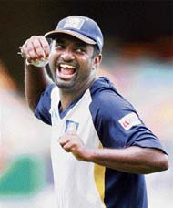 Muttiah Muralitharan (R) shares a lighter moment at the Gabba in Brisbane on Monday.