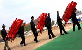 The workers remove chairs after a function held at Barnala road in the city.