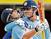 Sachin Tendulkar (L) celebrates completing his 16000 one-day runs with team mate Virender Sehwag during their tri-series one-day international cricket match against Sri Lanka in Brisbane