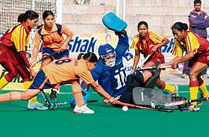 Haryana goalkeeper Savita Punia tries to thwart an attack by Jharkhand during the semifinal of the 55th Rakshak Senior Women�s National Hockey Championship in Jalandhar on Friday.