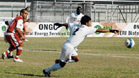 Nepolean Singh (right) of Air India runs to catch the ball as Eduardo (left) of JCT looks on in the 16th round match of the ONGC-I Football League played at Guru Nanak Stadium, Ludhiana on Sunday.