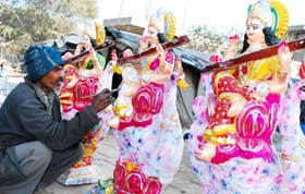 An artist gives final touches to goddess Saraswati�s idol for Basant Panchami celebrations in Bathinda on Monday.