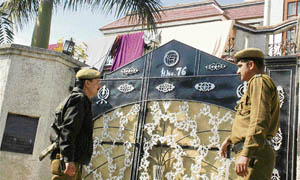 Policemen stand outside the house of Dr Amit�s father-in-law Sham Lal Saini in Digiana on the outskirts of Jammu on Friday.