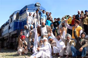 Members of the Action Committee, formed to protest against the unbundling of the PSEB, stopping a train at Rampura Phul in Bathinda district on Tuesday