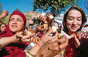 Supporters of slain opposition leader Benazir Bhutto offer sweets to each other to celebrate their victory in the general elections in Peshawar on Tuesday.