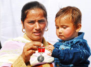 Manjeet Kaur, widow of Sapper Harpal Singh, showing the award given in recognition of her husband�s sacrifice.