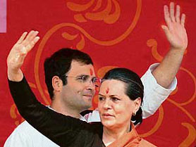 Congress president Sonia Gandhi and her MP son Rahul Gandhi wave to supporters during the centenary celebrations of the Bank of Baroda at Rae Bareli, Uttar Pradesh, on Wednesday.