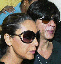 Bollywood actor and co-owner of the Kolkata cricket team, Shahrukh Khan, along with wife Gauri arrives for the inaugural Indian Premier League (IPL) Twenty20 players' auction in Mumbai on Wednesday. 