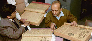 Noorul Hoda (right), curator of Supreme Court of India Museum, and Rajmani of National Archives of India search for materials on Bhagat Singh in The Tribune files at the office on Tuesday.