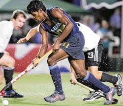 Ignace Tirkey dribbles past an Austrian player during their match at the hockey Olympic qualifying tournament in Santiago on Sunday.