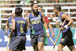 Rajpal Singh (centre), Tushar Khandekar (right) and Shivendra Singh celebrate after scoring a goal against Mexico during the hockey Olympic qualifying match in Santiago