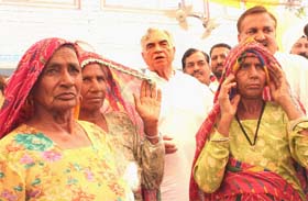Women in traditional attire greet Governor of Madhya Pradesh, Balram Jakhar, in village Panjkosi