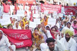 Landless peasants, both men and women, demonstrating for waiving of their loans and for issuance of blue cards under the atta-dal scheme